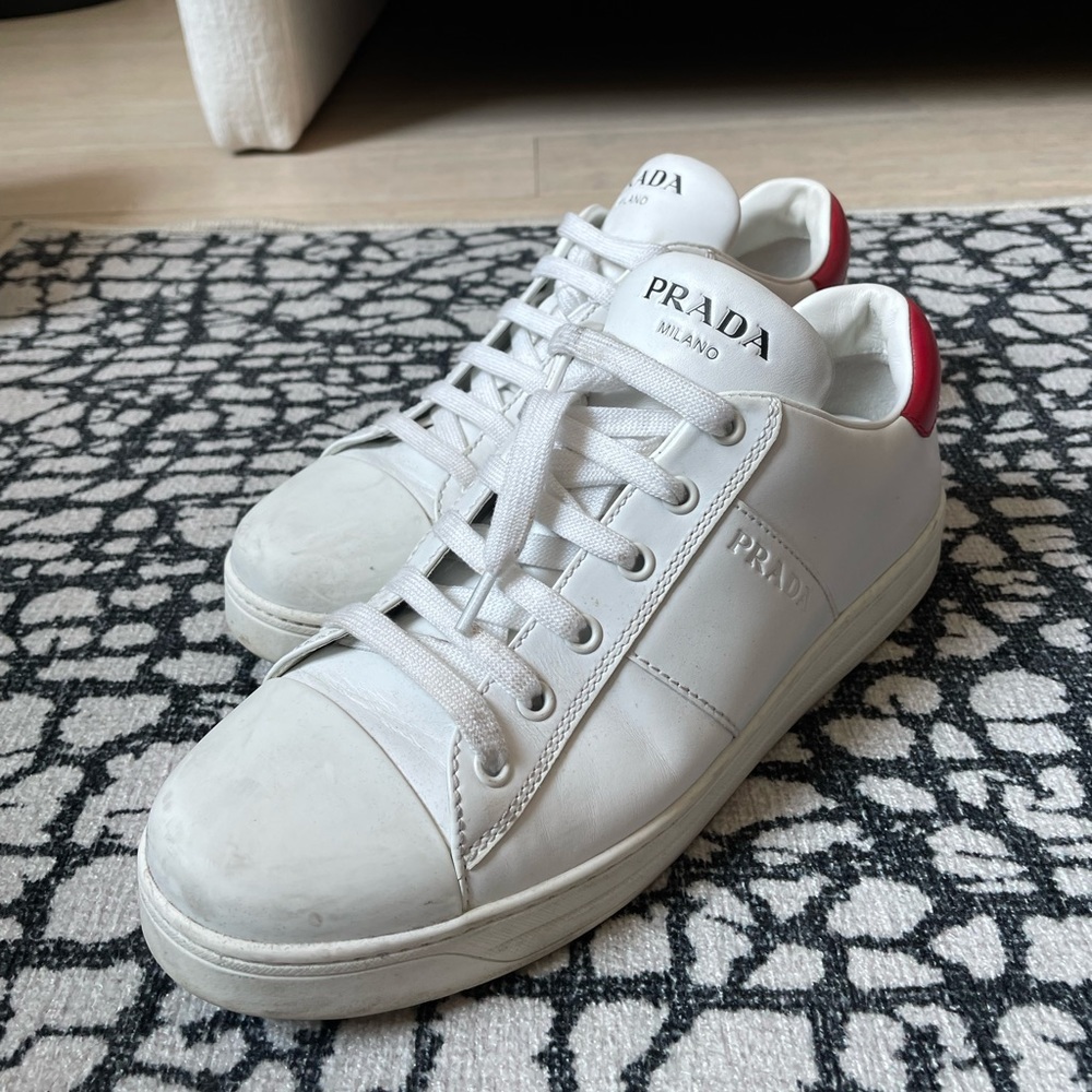 White Prada Sneakers w/red heel tab. W10